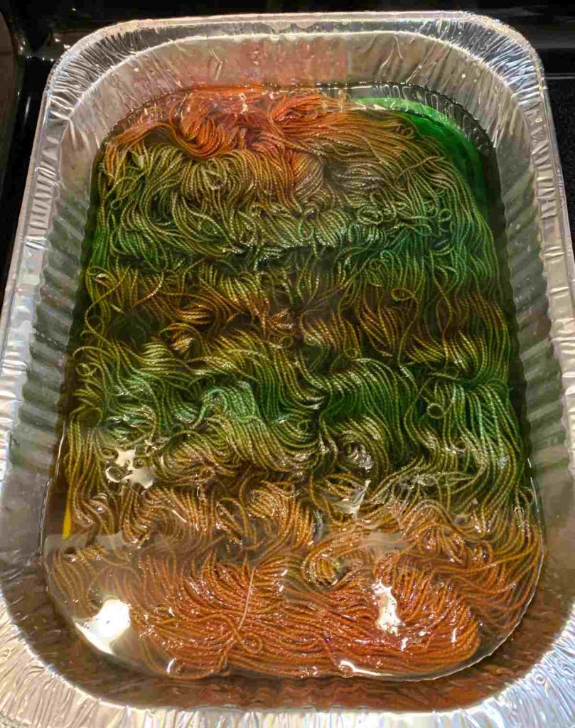 image of a roasting pan with colored yarn