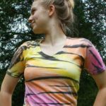 a girl wearing a yellow and black striped shirt